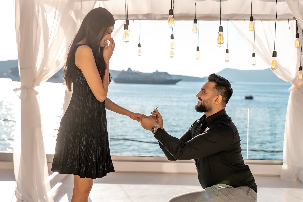 A sunset proposal on one knee on AION's private terrace in Fira