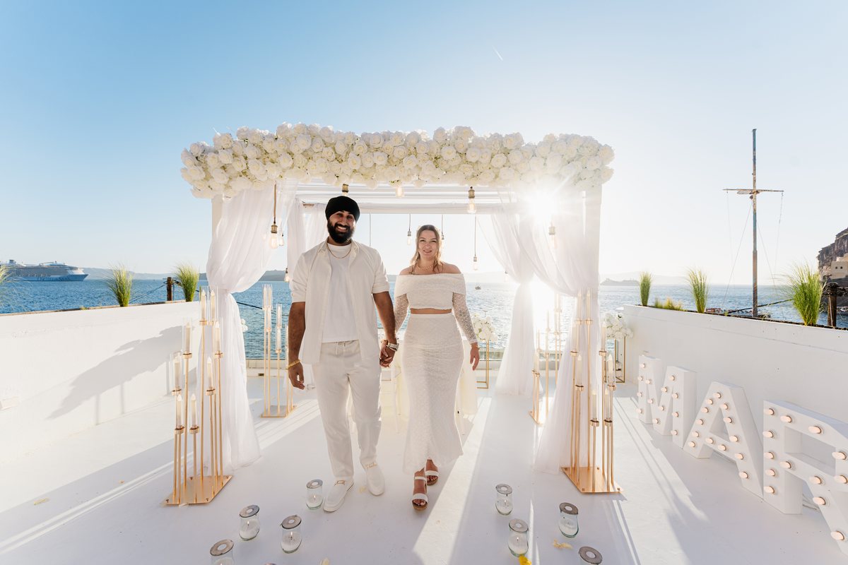 AION's terrace dressed for a wedding: a white aisle running the length of the floor to the water