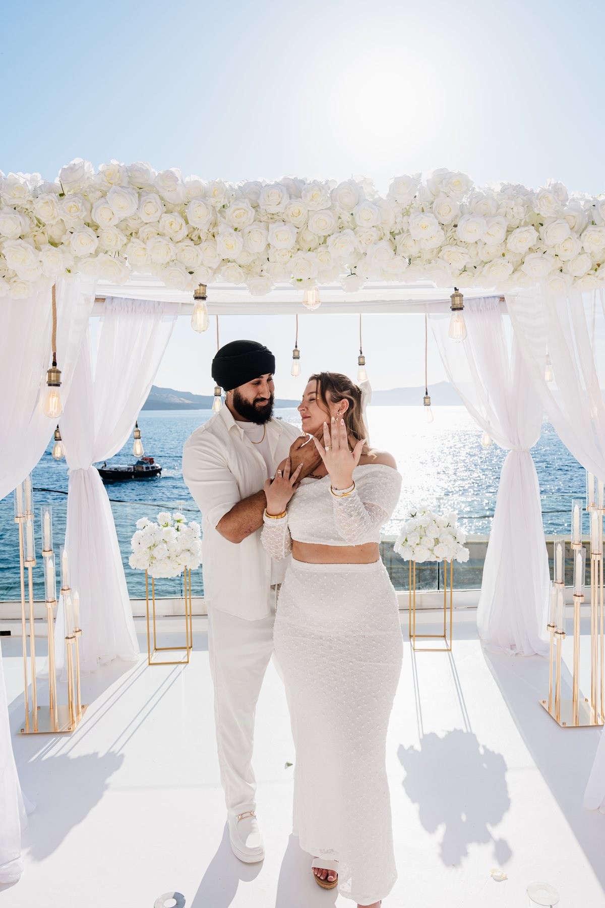 A couple holding each other on AION's terrace after the ceremony