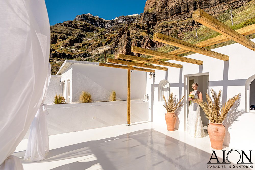Grace and Brennan during their wedding ceremony at AION Santorini