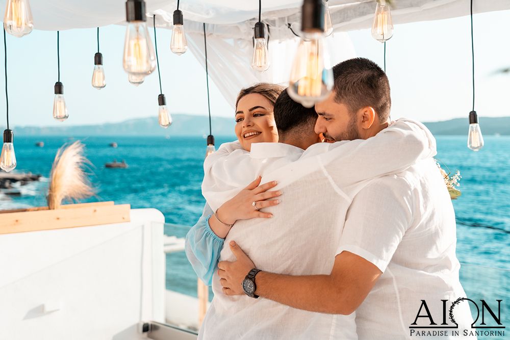 A long embrace under the hanging bulbs after the proposal