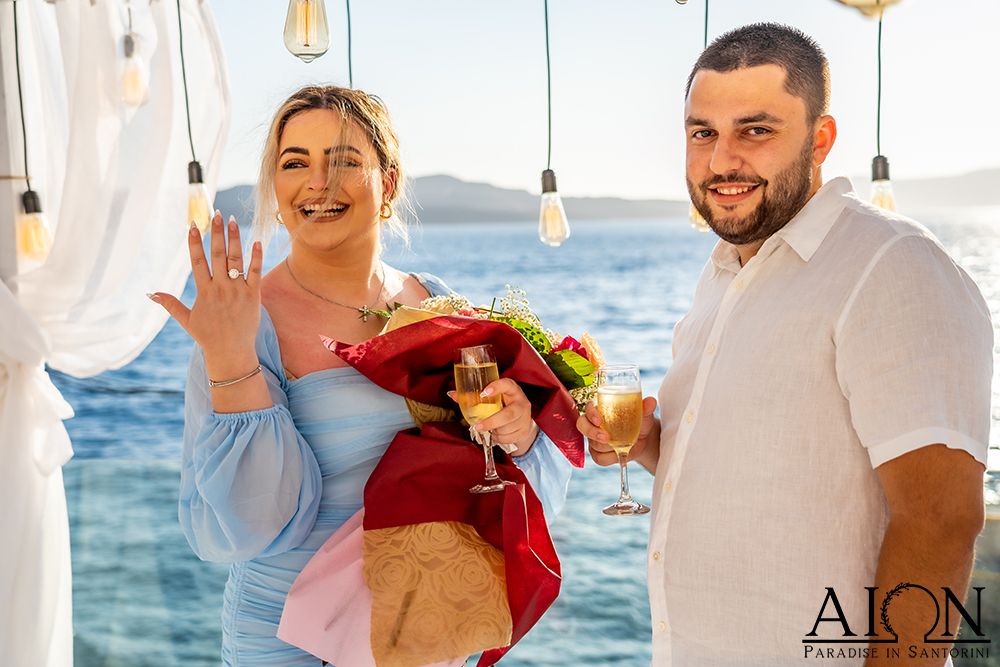 Moments after the yes - the ring shown, bouquet and champagne in hand