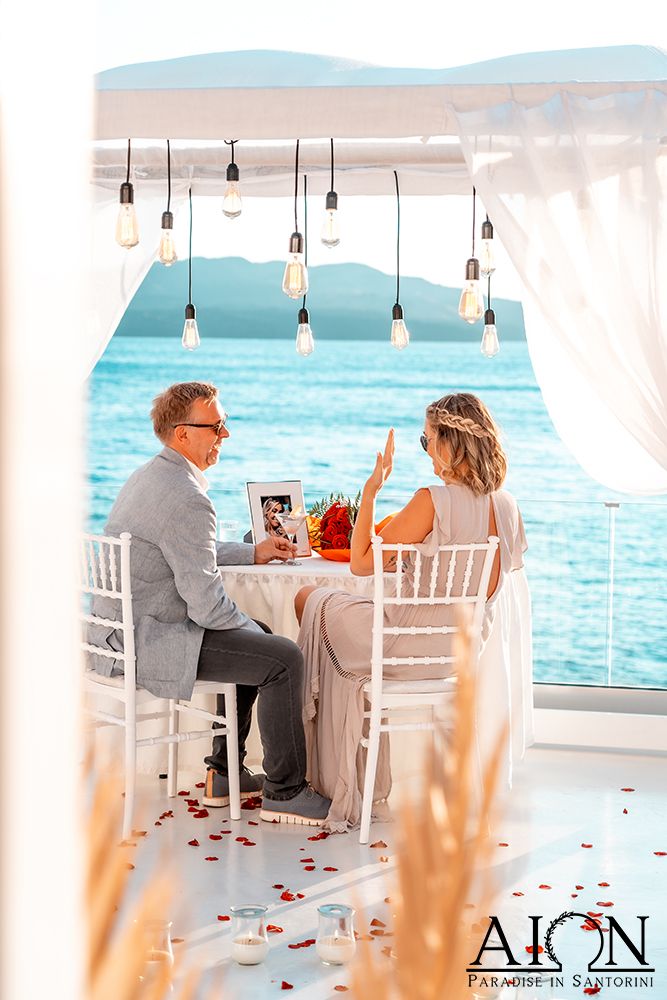 A champagne toast at the petal-strewn table after she said yes
